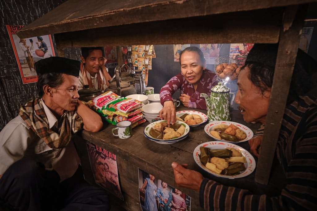 A heartwarming scene of friends enjoying traditional snacks at a cozy warung in South Jakarta, Indonesia.